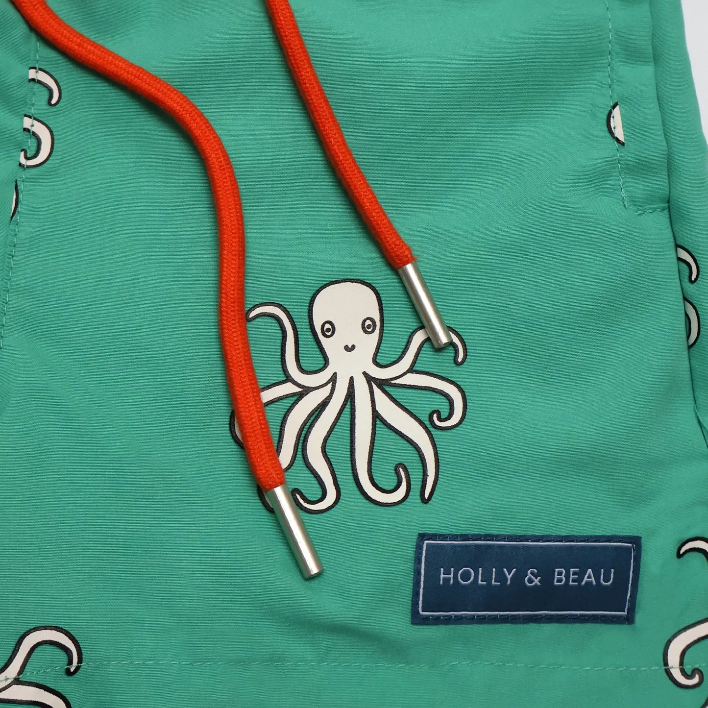 holly and beau front drawstring and logo view of the color changing swim trunks
