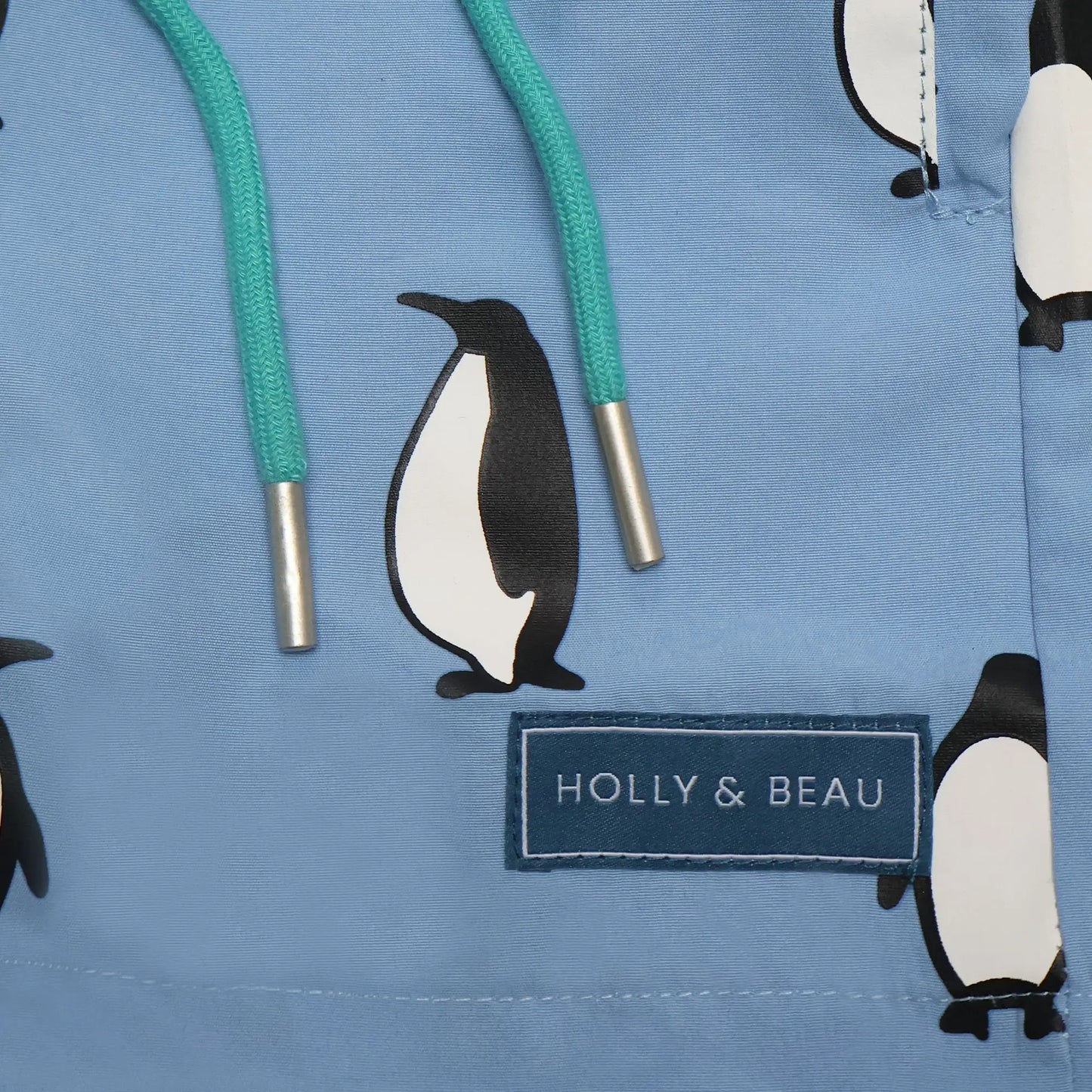 Holly and Beau light blue penguin boys color changing swim trunks. Front detail drawstring and logo