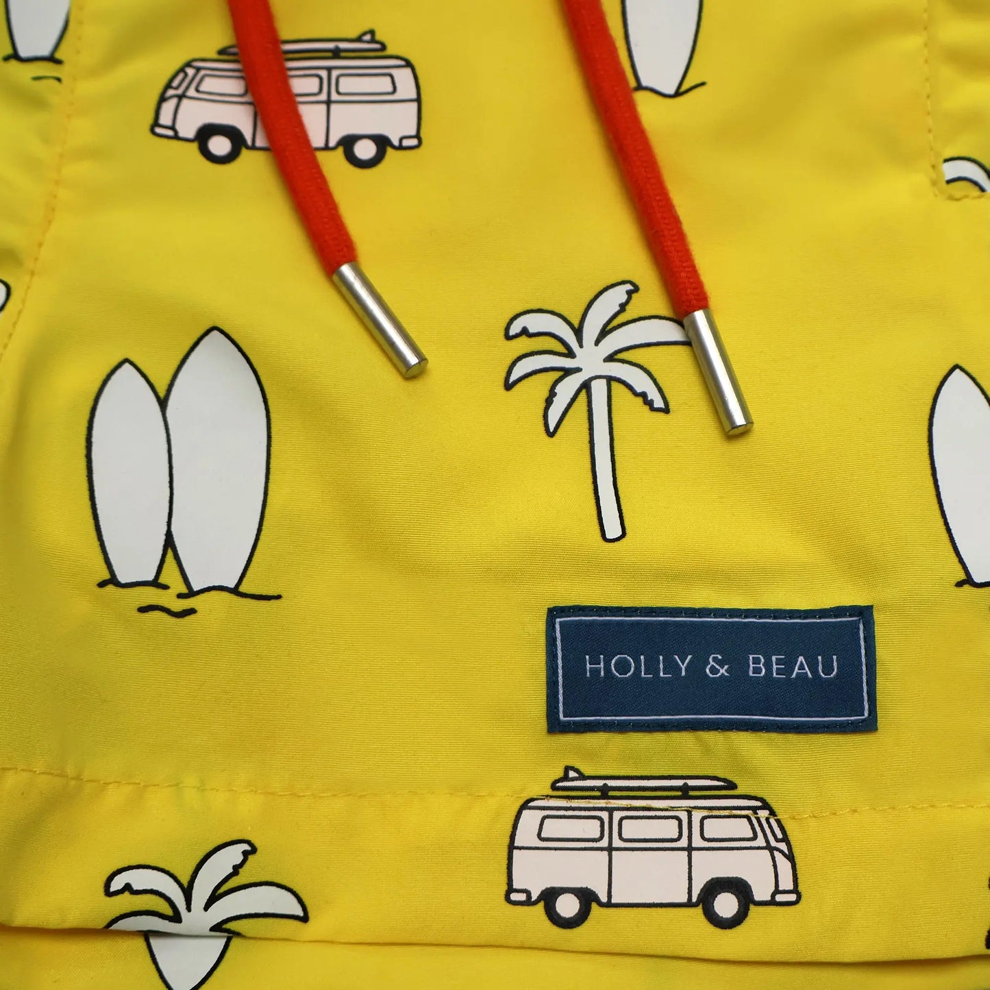 Holly and Beau Yellow surfboards boys color changing swim trunks detailed view of the drawstring and logo