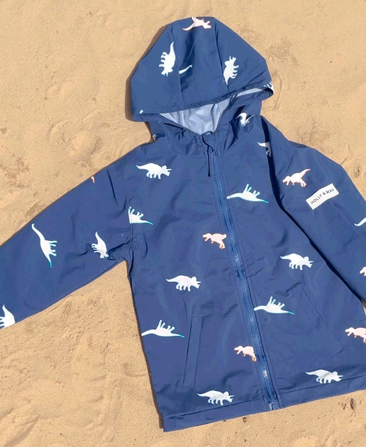 Kids dinosaur color changing raincoat by Holly and Beau. Gif showing the process of the color changing raincoat.