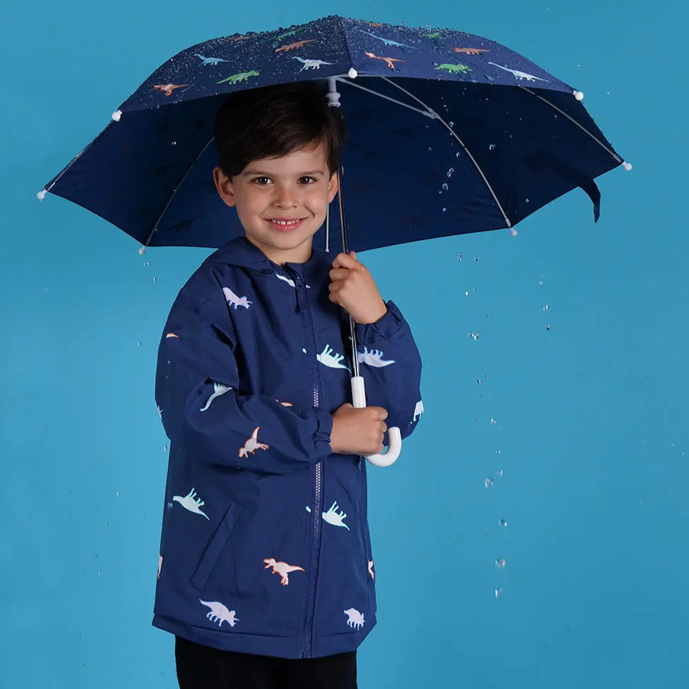 Holly and Beau boy smiling wearing color changing dinosaur raincoat