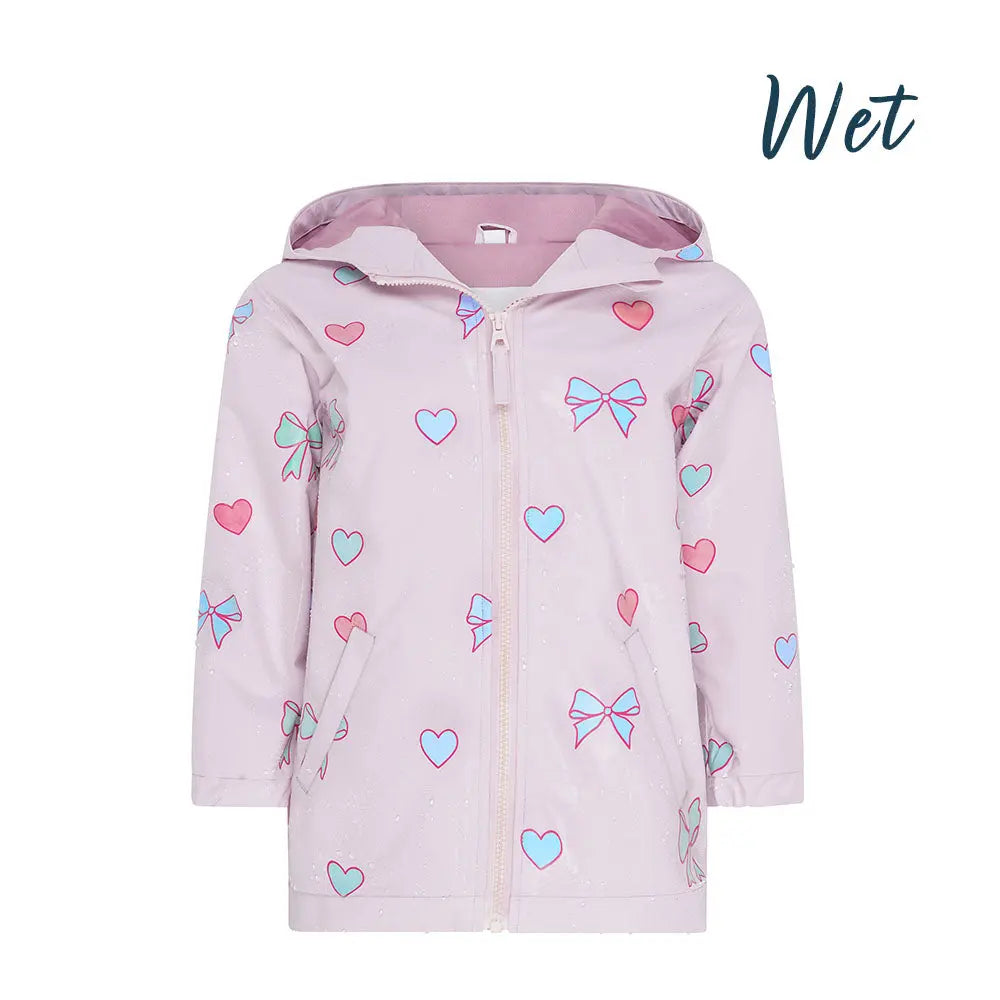 Wet front view of the pink bows and hearts color changing raincoat by Holly and Beau