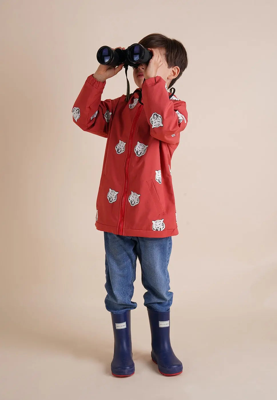 Holly and Beau Toddler boy wearing his red tiger color changing raincoat