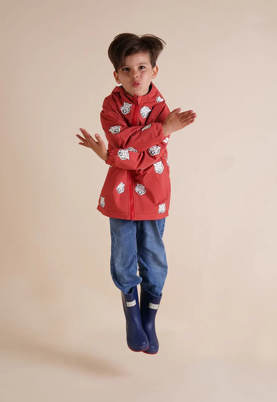 Holly and Beau jumping boy wearing red tiger color changing raincoat